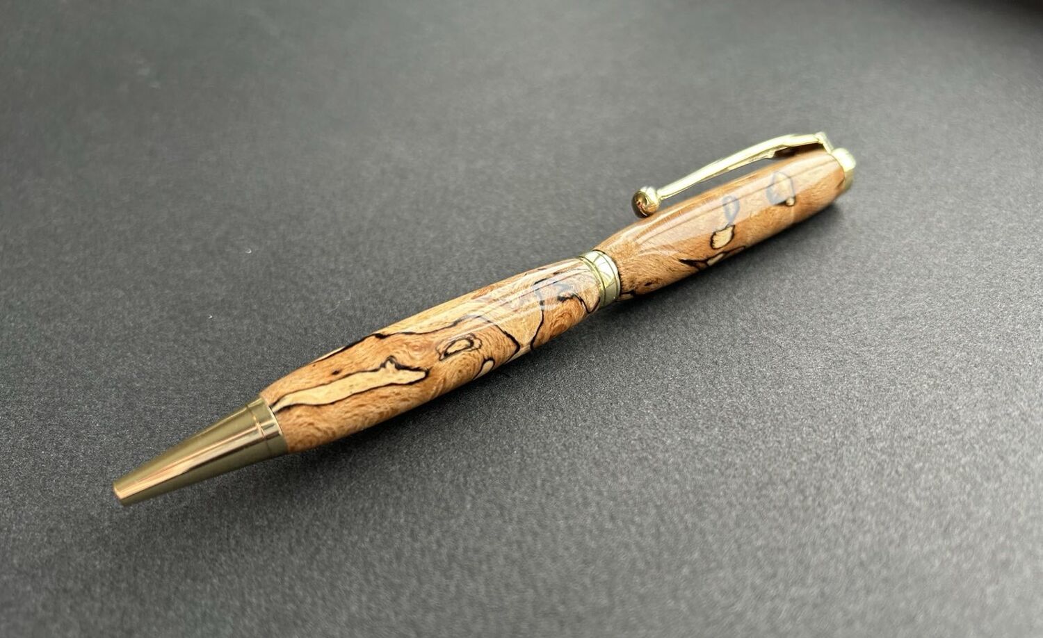 Artisan using lathe in woodworking workshop