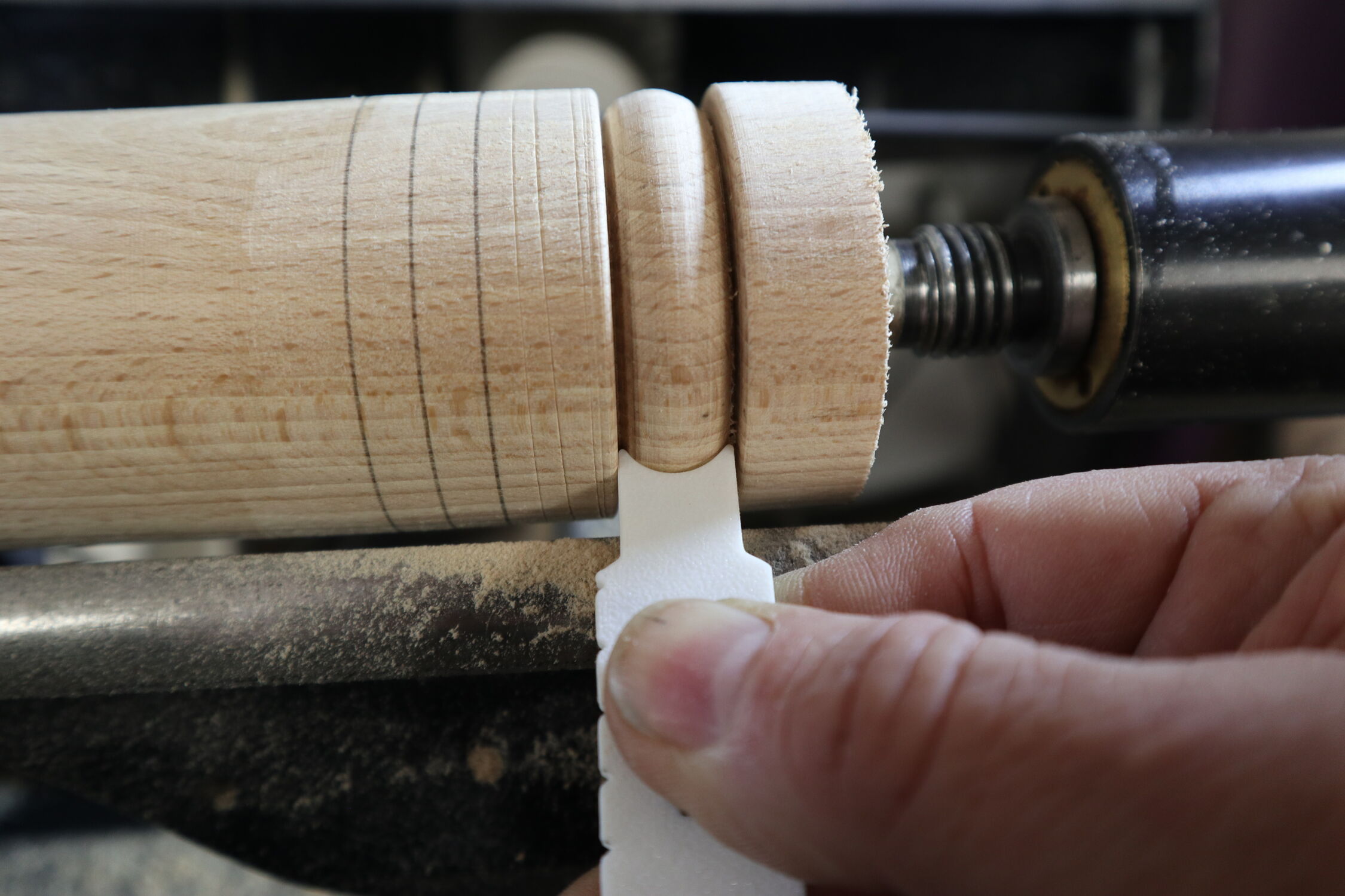 Artisan shaping wood on lathe